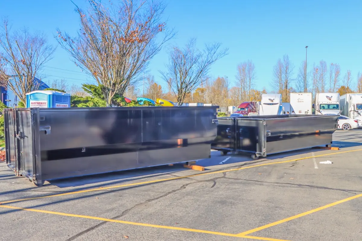 Professional dumpster rental service with roll-off container on residential driveway in Johnstown